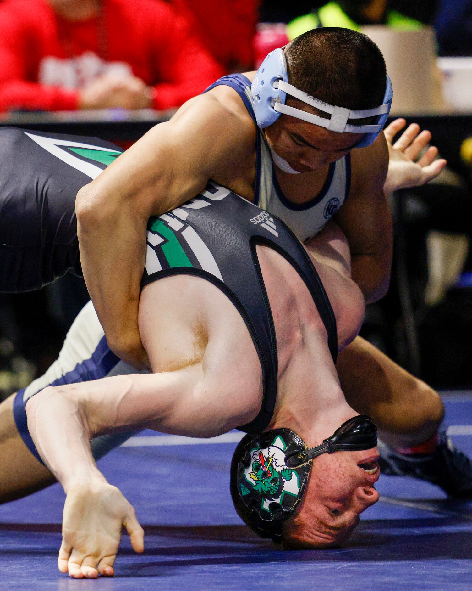 Cole Bennett of Southlake Carroll (bottom) wrestles Kyle Lew of Houston Westside during a...