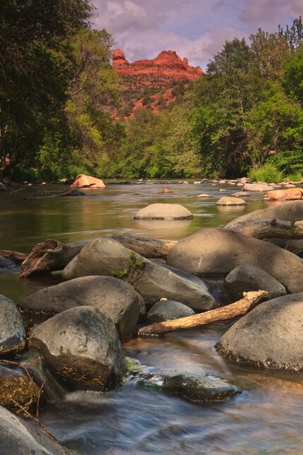 The rocky Giant's Thumb towers over a creek in Sedona.