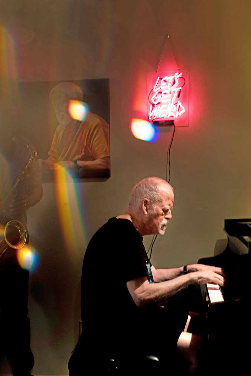A photo taken through a prism shows Dave Zoller playing piano in his living room on Friday,...
