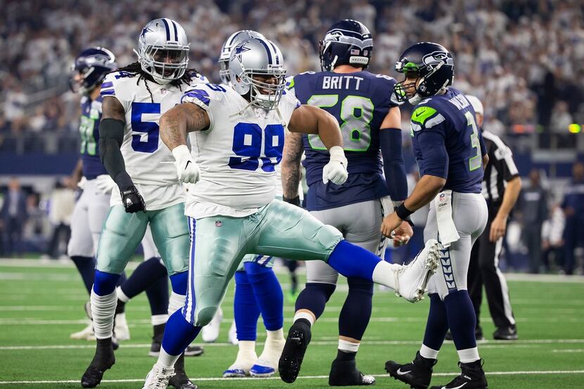 Cowboys defensive tackle Antwaun Woods (99) celebrates after sacking Seattle Seahawks...