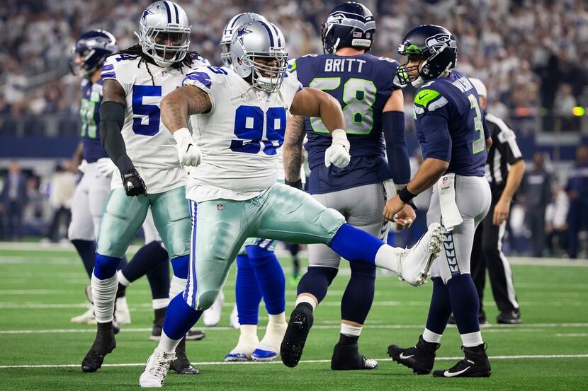 Cowboys defensive tackle Antwaun Woods (99) celebrates after sacking Seattle Seahawks...