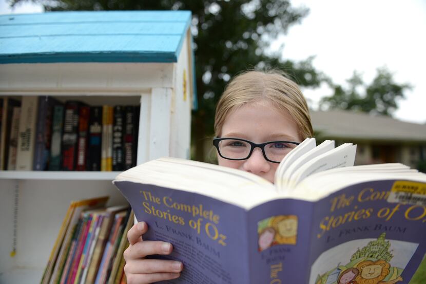 Hannah Wahl, 11, is the steward of her Little Free Library on Malcolm Drive in Lakewood. The...