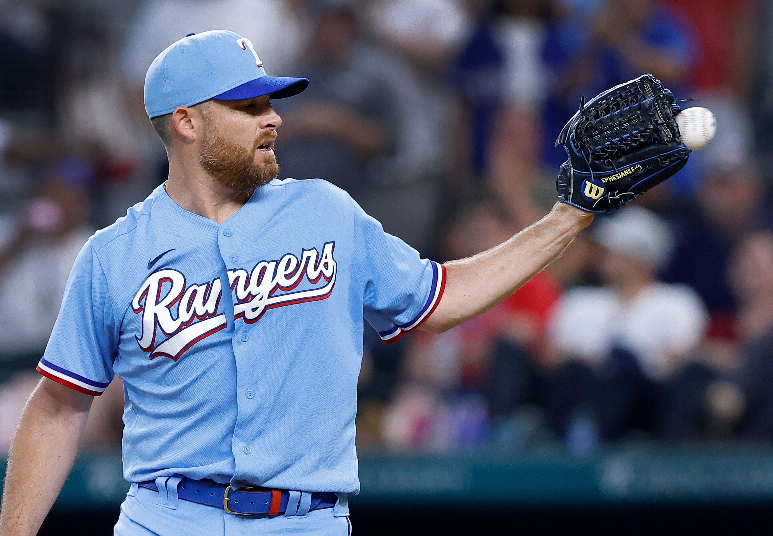 Texas Rangers relief pitcher Ian Kennedy (31) receives the ball during the ninth inning...