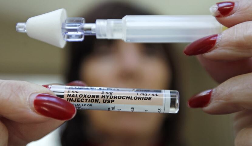 File photo of woman holding up a tube of Naloxone Hydrochloride, also known as Narcan. The...