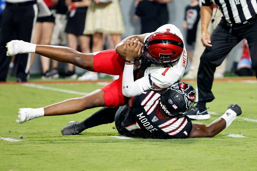 Texas Tech's Donovan Smith is sacked for a loss by North Carolina State's Isaiah Moore...