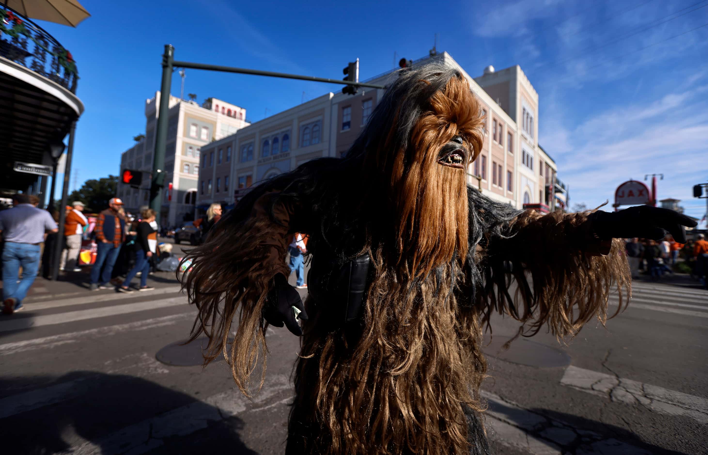 A person dressed as Chewbacca from Star Wars greets people to the Mardi Gras-style Allstate...