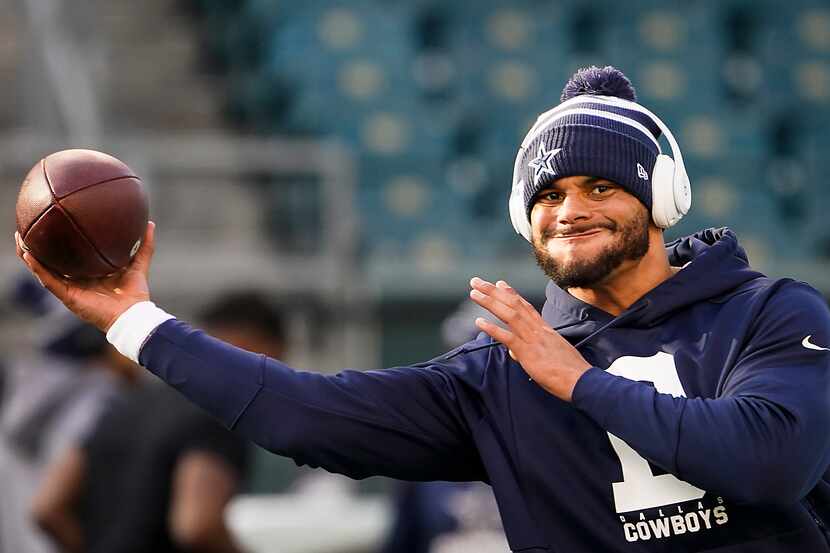 Dallas Cowboys quarterback Dak Prescott warms up before an NFL football game against the...