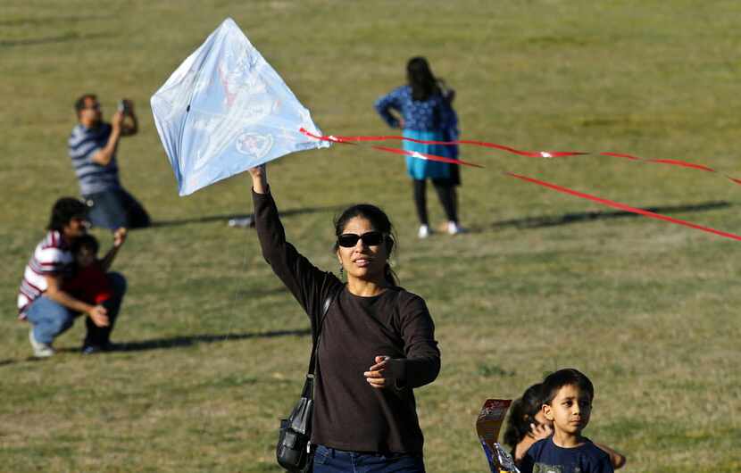 Vidya Konda of Plano tried keep her son's kite afloat in the light breezes at the Kite...