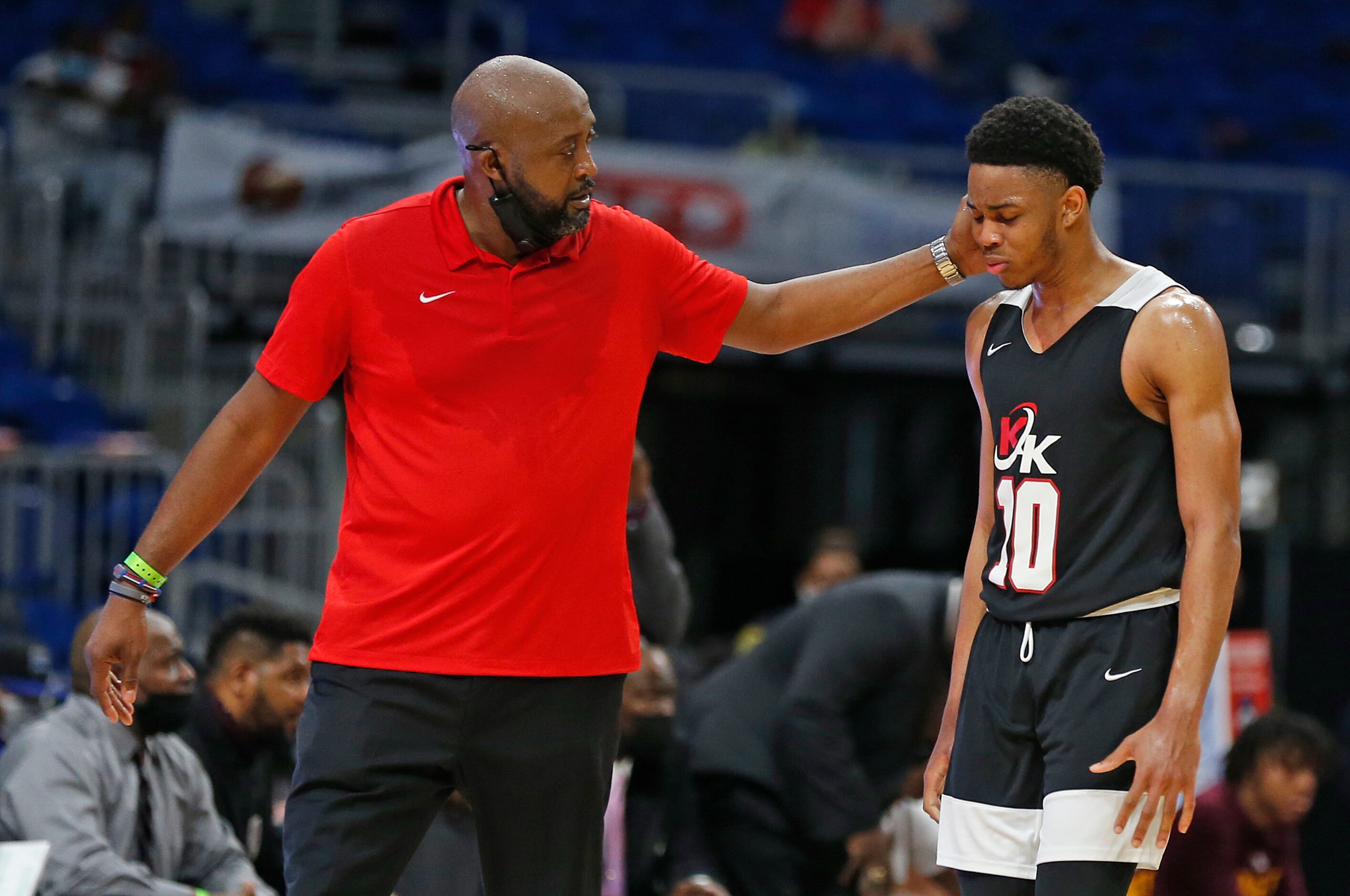 Dallas Kimball head coach Nicke Smith consoles Dallas Kimball Deonte Greer #10 after he...