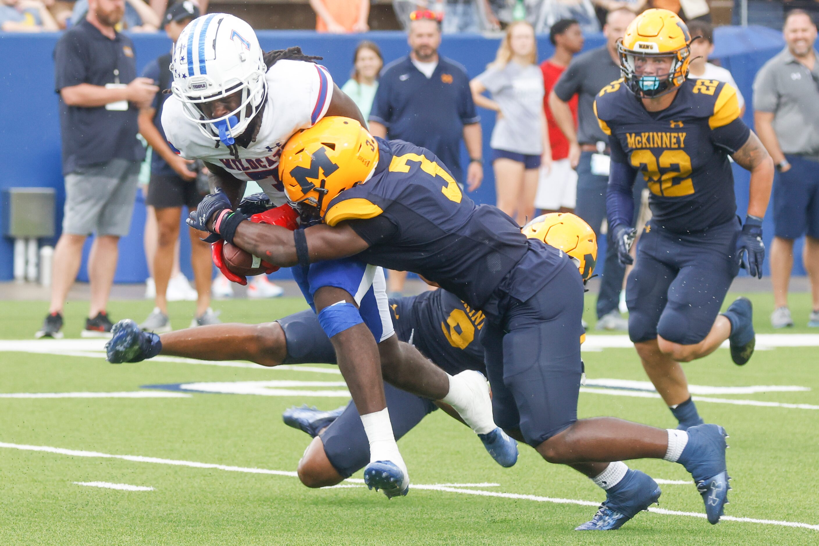 Temple High’s Mikal Harrison-Pilot (7), left, gets tackled by  McKinney High’s Myles Elam...