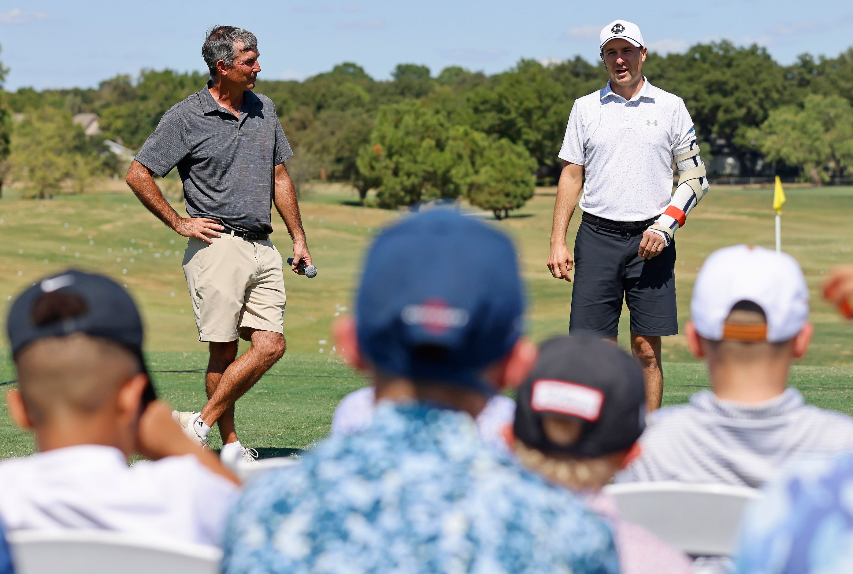 PGA Tour pro Jordan Spieth (right) speaks to junior golfers alongside his childhood coach,...