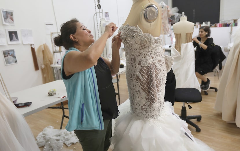 Blanca Salgueros, a seamstress at Esé Azénabor's shop in Dallas, Texas, Wednesday, October...