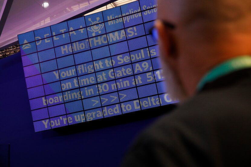 An attendee looks at a screen with information unique to him the parallel reality experience...