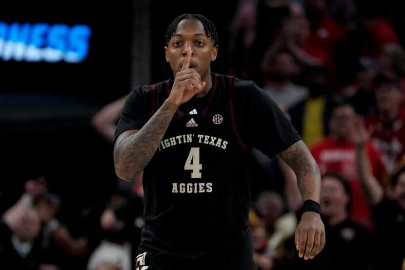 Texas A&M guard Wade Taylor IV (4) celebrates a three-point basket during the first half of...