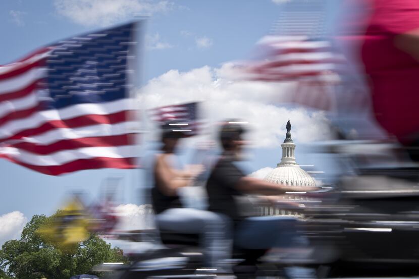 Bikers with US banners ride in front of the US Capitol as they take part in the annual...