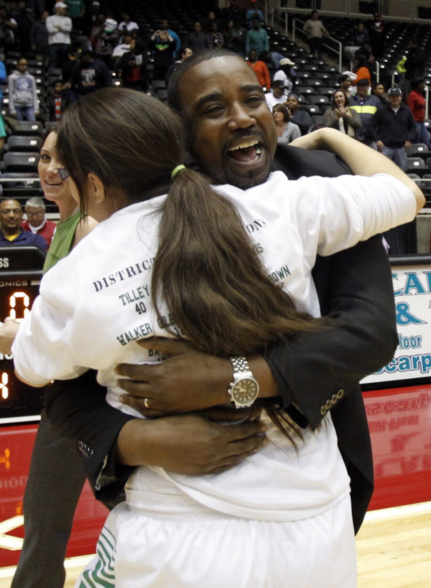 Bryan Adams head coach Darren Eubanks   celebrates with a player after winning the Class 5A...