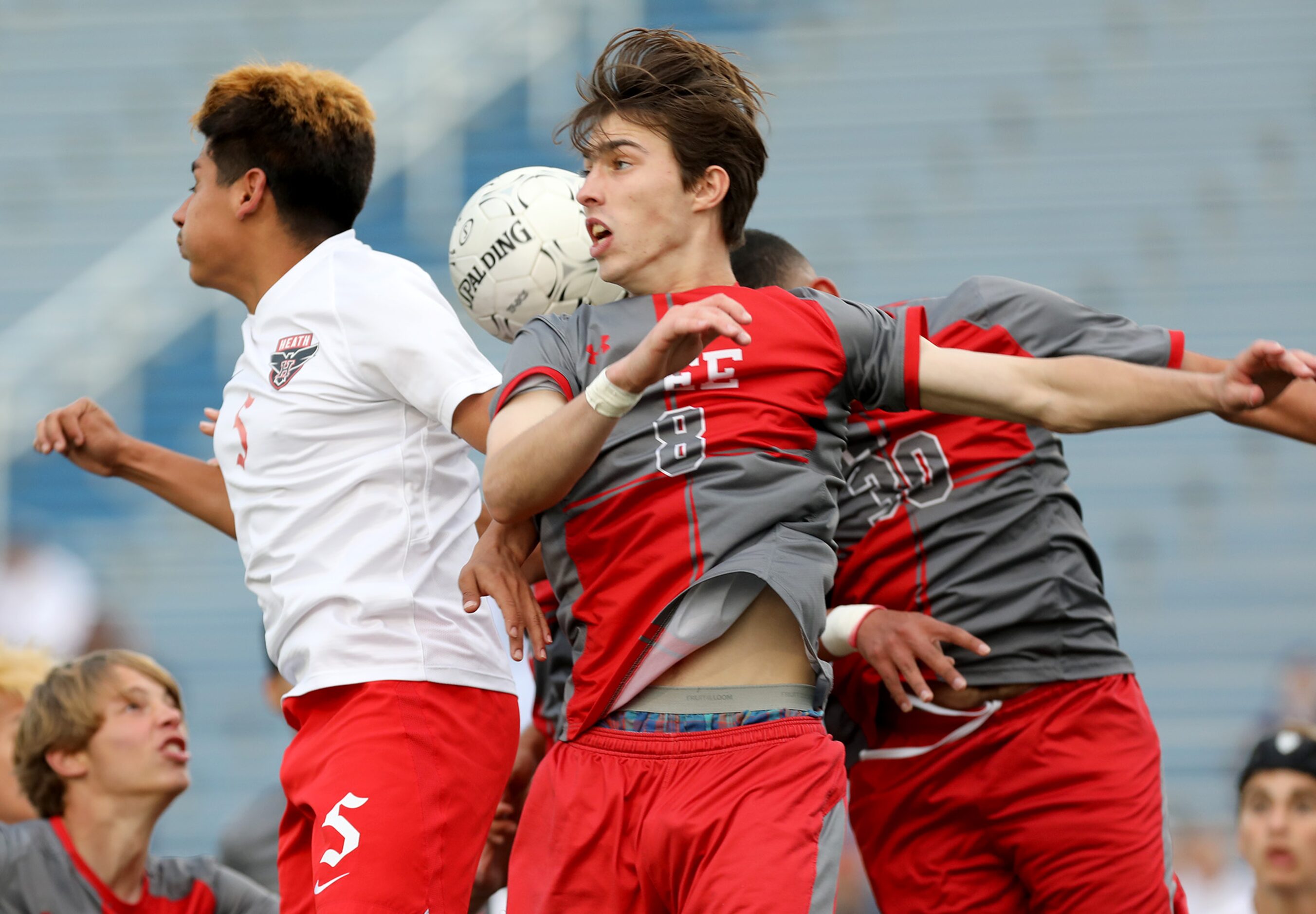 Rockwall-Heath's Chris Rodriguez (5) SA Lee's Gavin Seesholtz (8),  and Jesus Blanco (30) go...