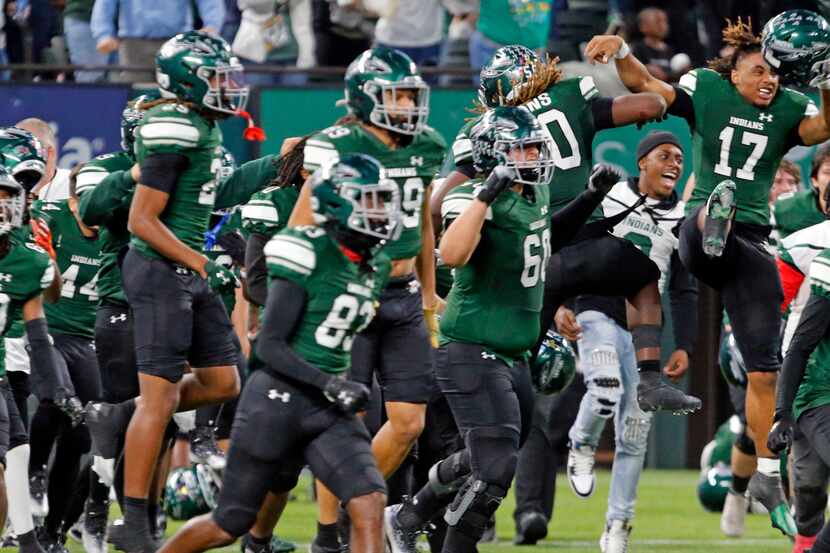 Waxahachie high players run onto the field after winning a high school football game over...