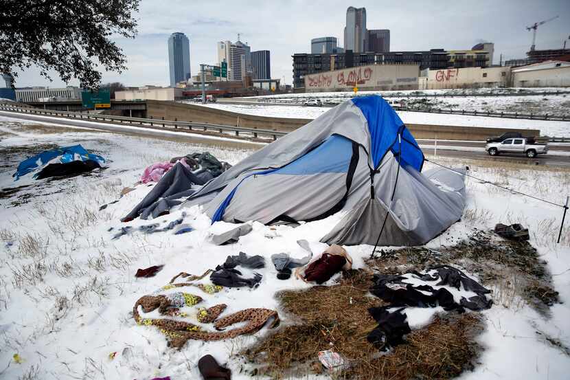 Snow-covered tents pitched along Interstate 30 were abandoned by their owners as a snow...