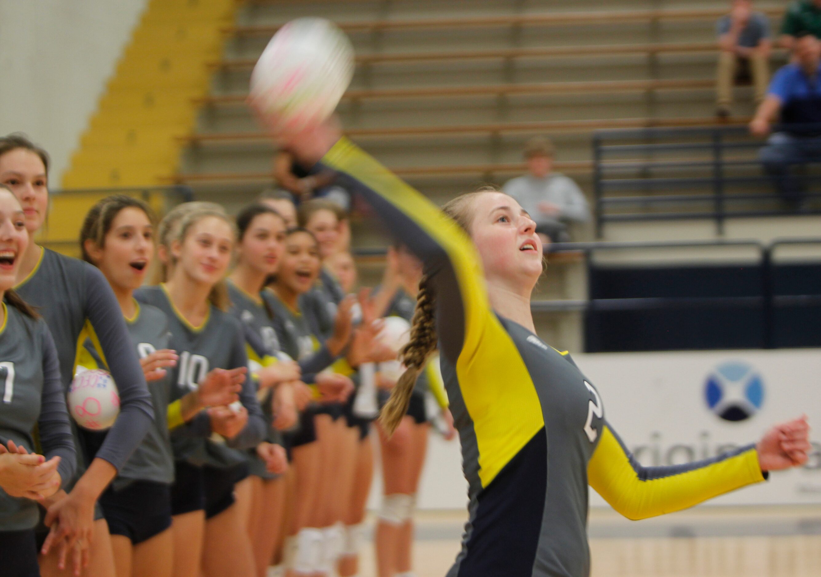 Highland Park setter Harper Hall (2) launches a miniature souvenir volleyball into the crowd...