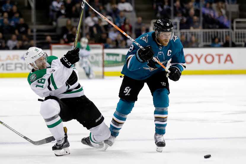 Dallas Stars' Tyler Pitlick, left, defends against San Jose Sharks' Joe Pavelski during the...