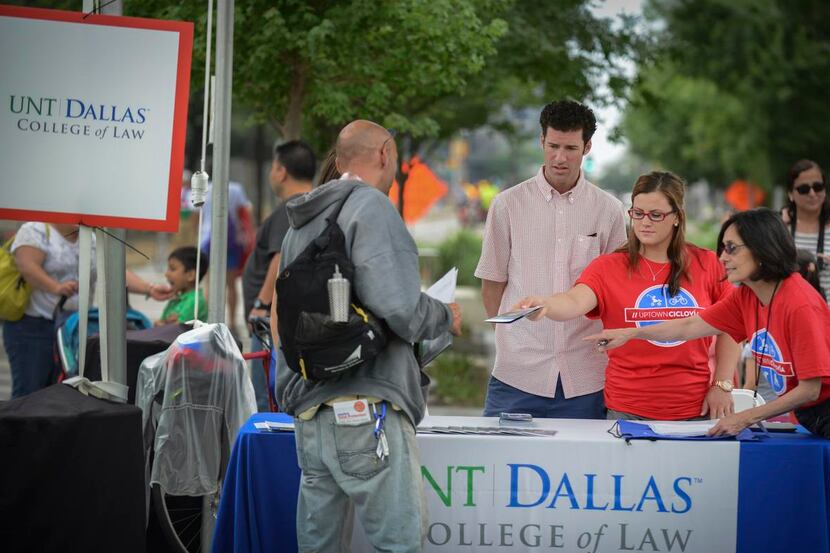 Rebecca Greenan, right, dean of students at UNT Dallas Law School, points out promotional...