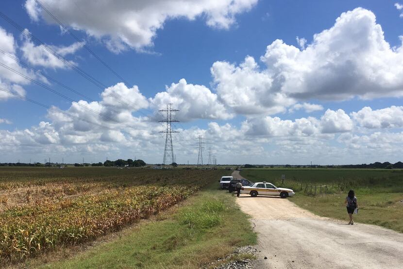 Police cars block access to the site where a hot air balloon crashed early Saturday, July...