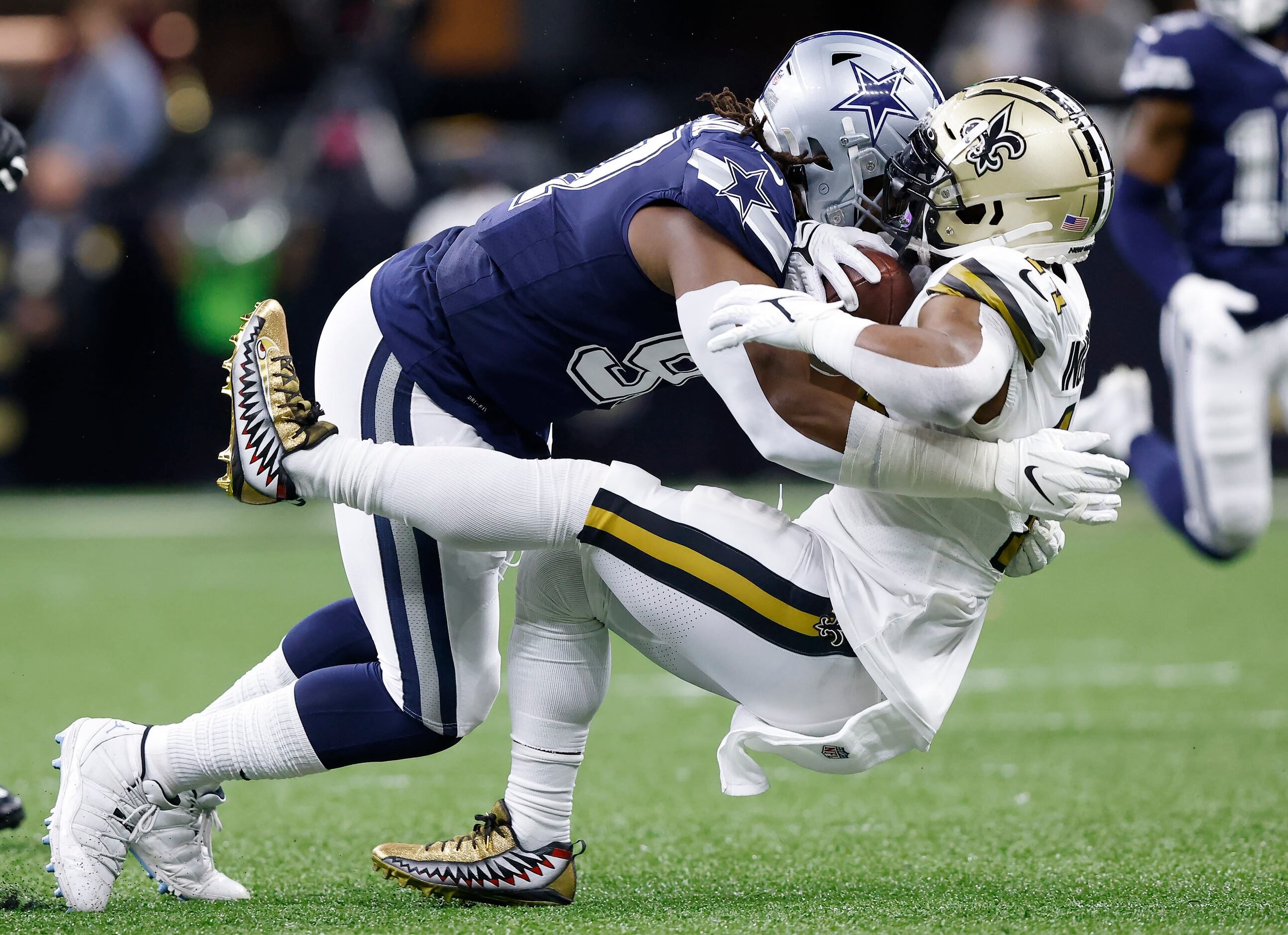 Dallas Cowboys defensive tackle Osa Odighizuwa (97) takes down New Orleans Saints running...
