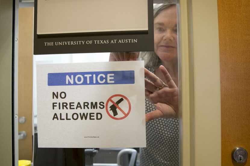 University of Texas at Austin Anthropology professor Pauline Strong posts a sign prohibiting...