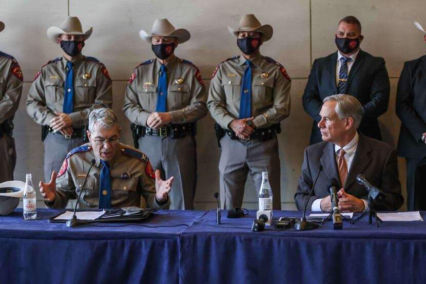 DPS chief Steve McGraw joins Gov. Greg Abbott during a press conference in Dallas, March 17,...