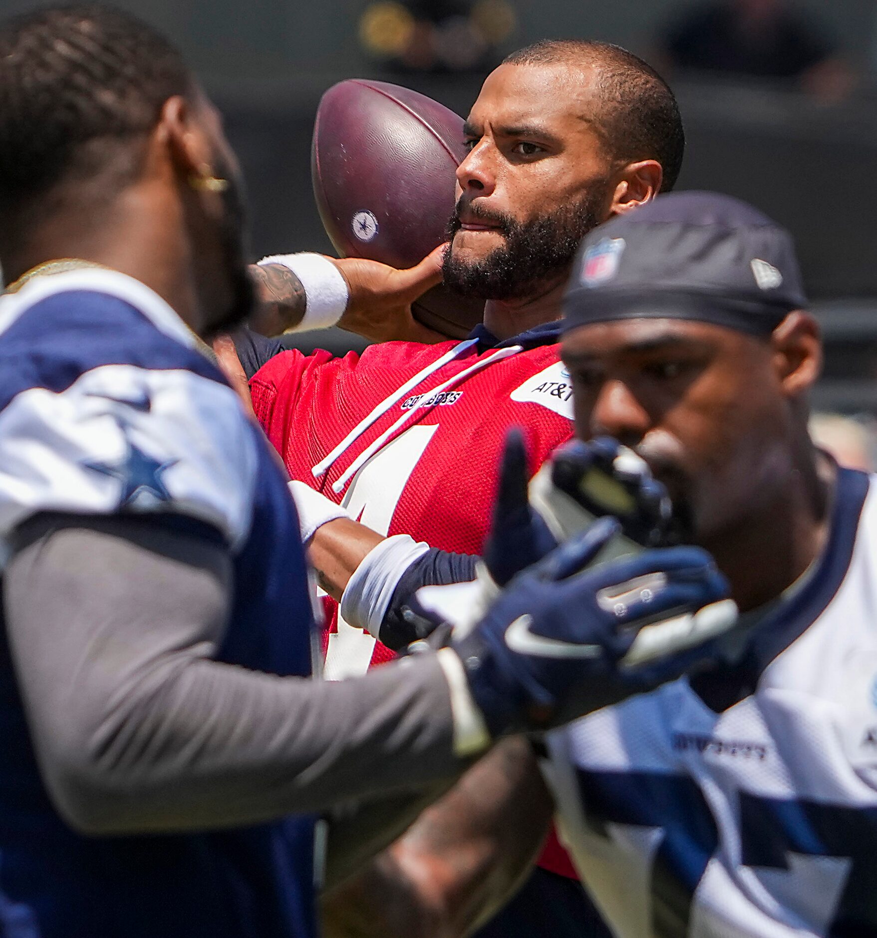 Dallas Cowboys quarterback Dak Prescott (4) throws a pass as tackle Tyron Smith (77) works...