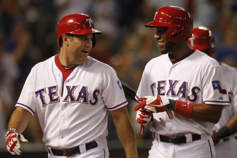 Texas Rangers designated hitter Lance Berkman (27)  shortstop Elvis Andrus (1) laugh after...
