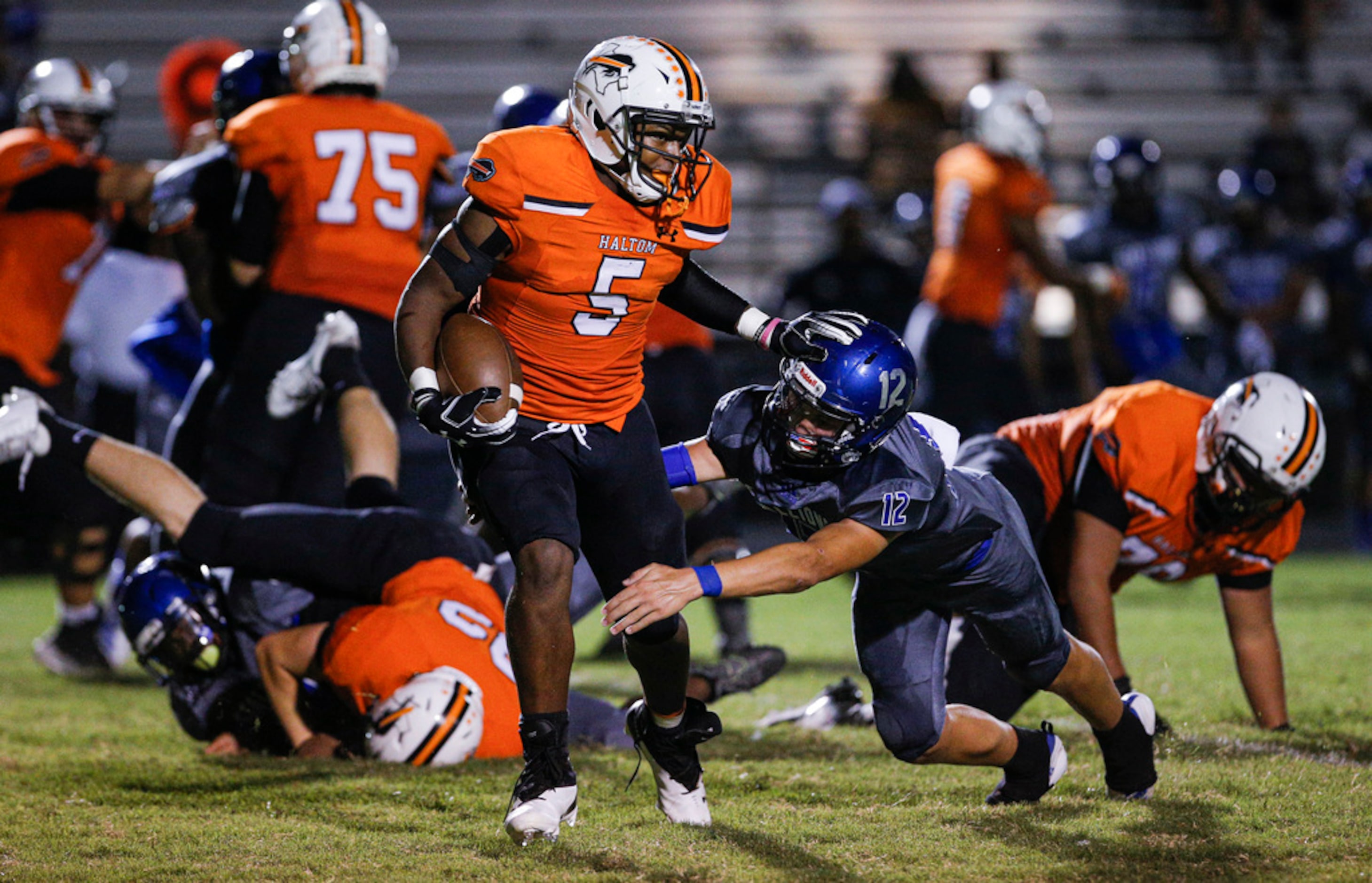 TXHSFB Haltom City senior running back Kenneth Cormier Jr. (5) looks for room against North...