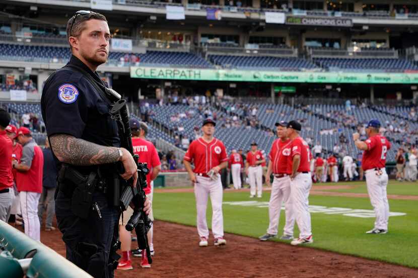 A member of the U.S. Capitol Police stands guard on the field as Congressional Republicans...