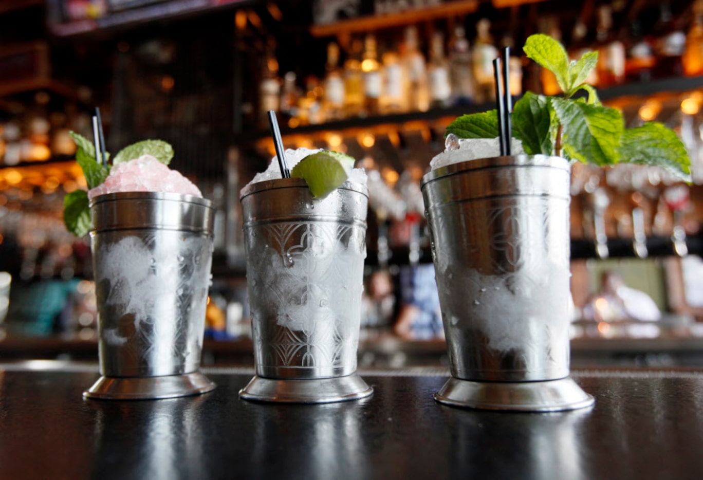 A trio of juleps (from left): Family Reunion with watermelon, Aperol and white whiskey; ...