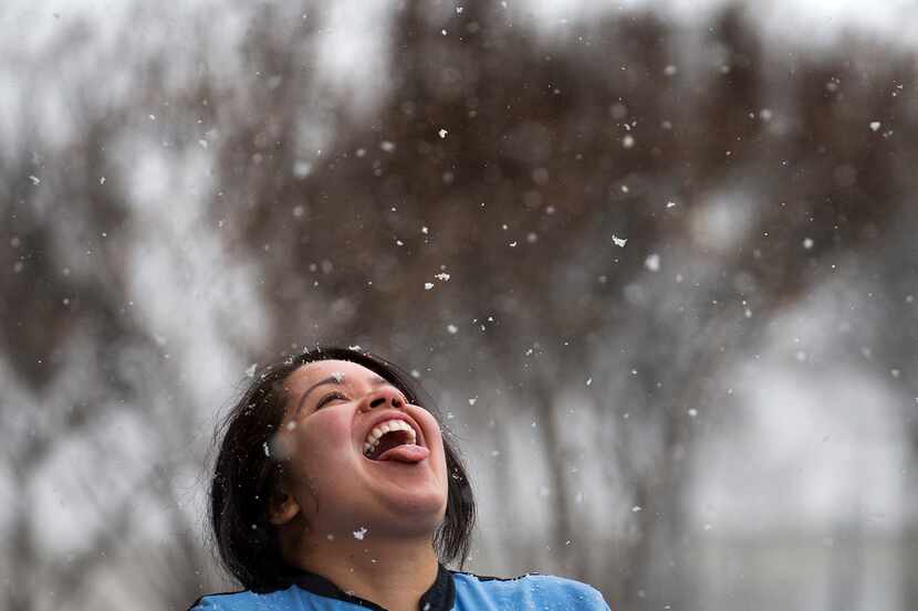 Racene Mendoza stepped outside her job at a Richardson bakery to try catching snowflakes in...