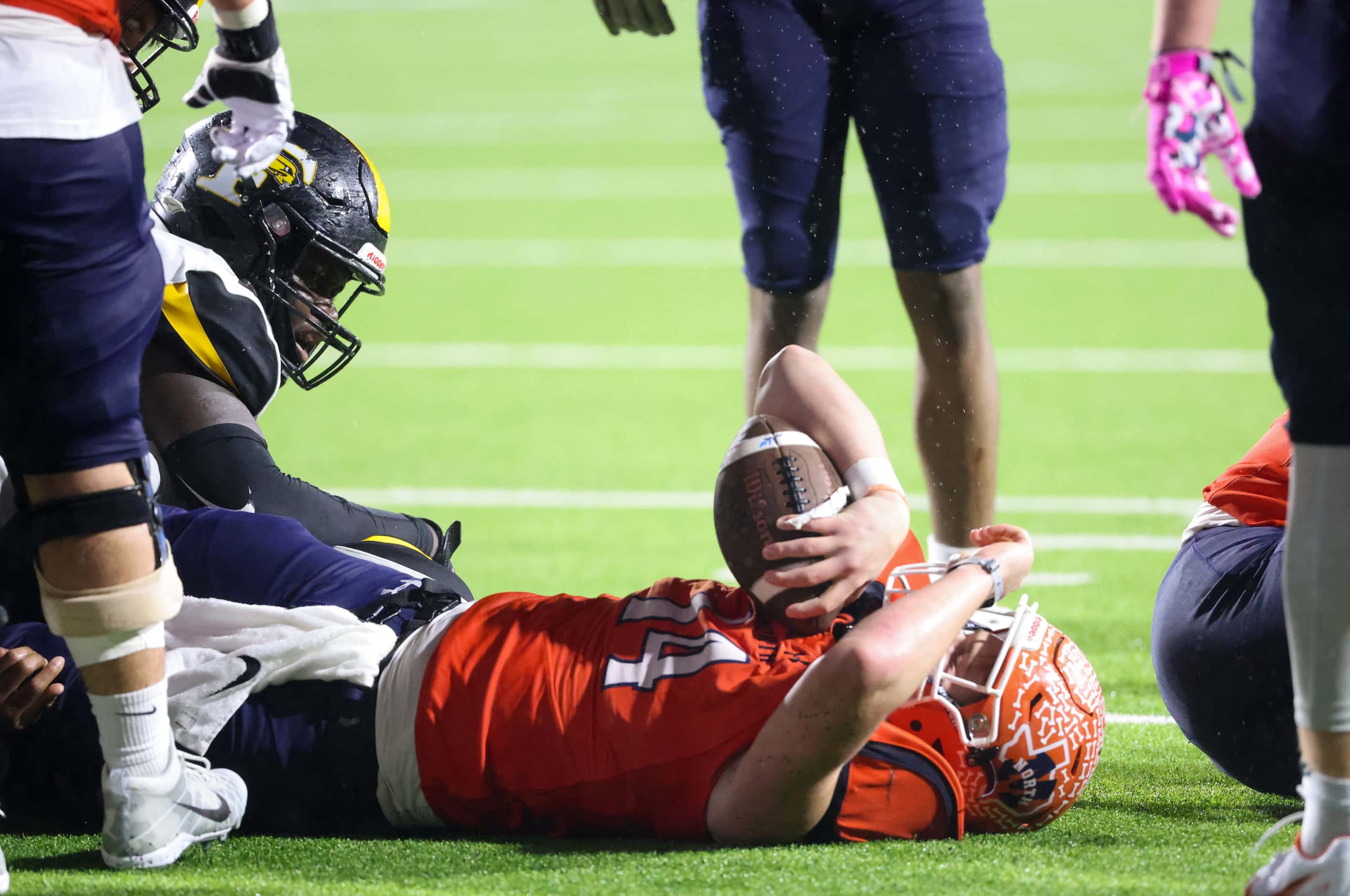  McKinney North quarterback Colin Hitchcock (14) lays on the ground after being tackled by...