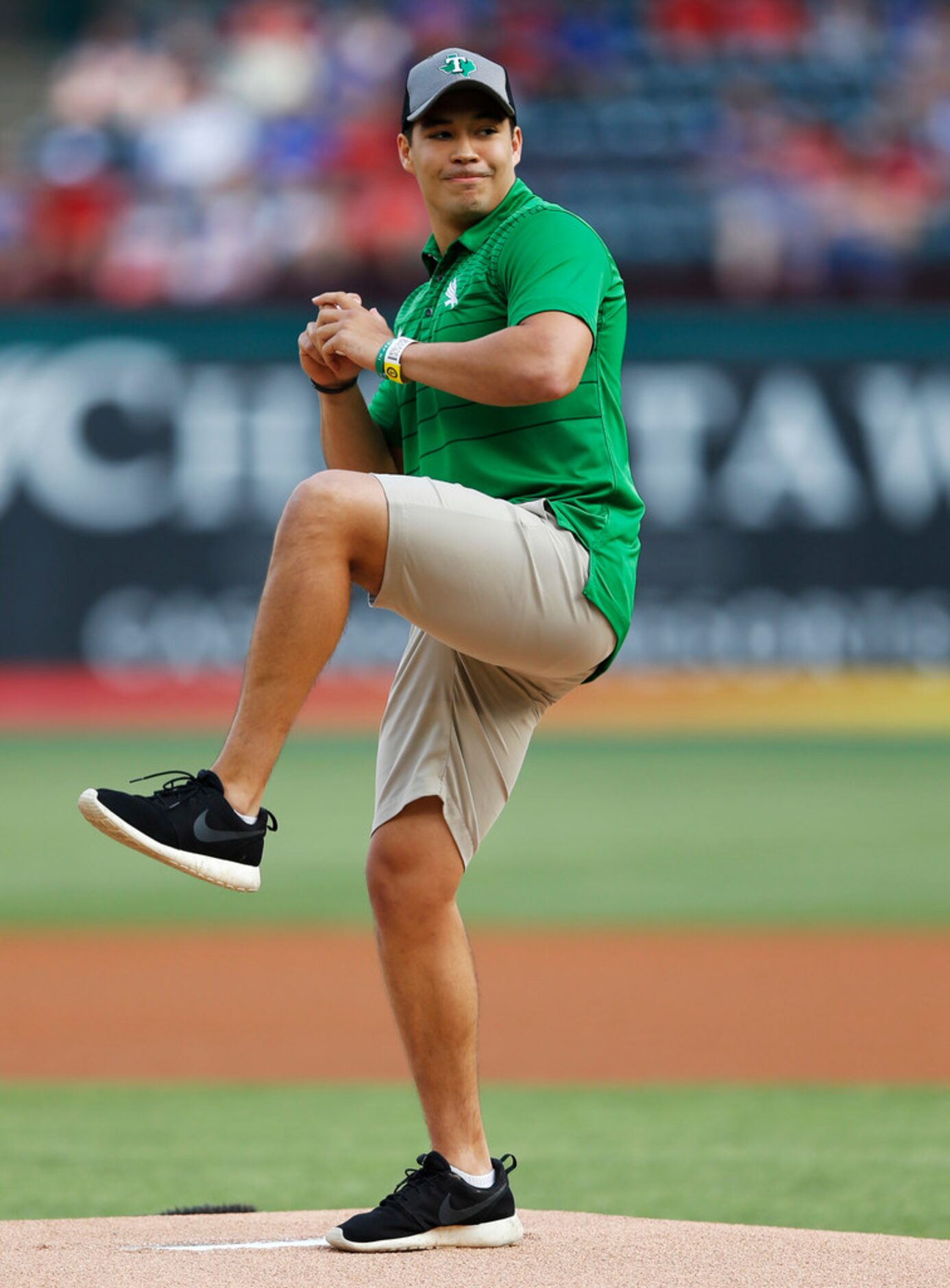 University of North Texas' quarterback Mason Fine throws the first pitch before a game...