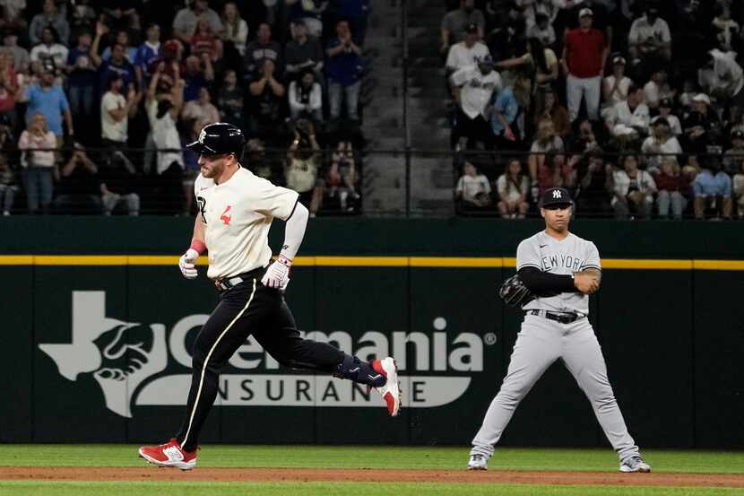 Texas Rangers' Robbie Grossman (4) runs the bases after hitting a two-run home run against...