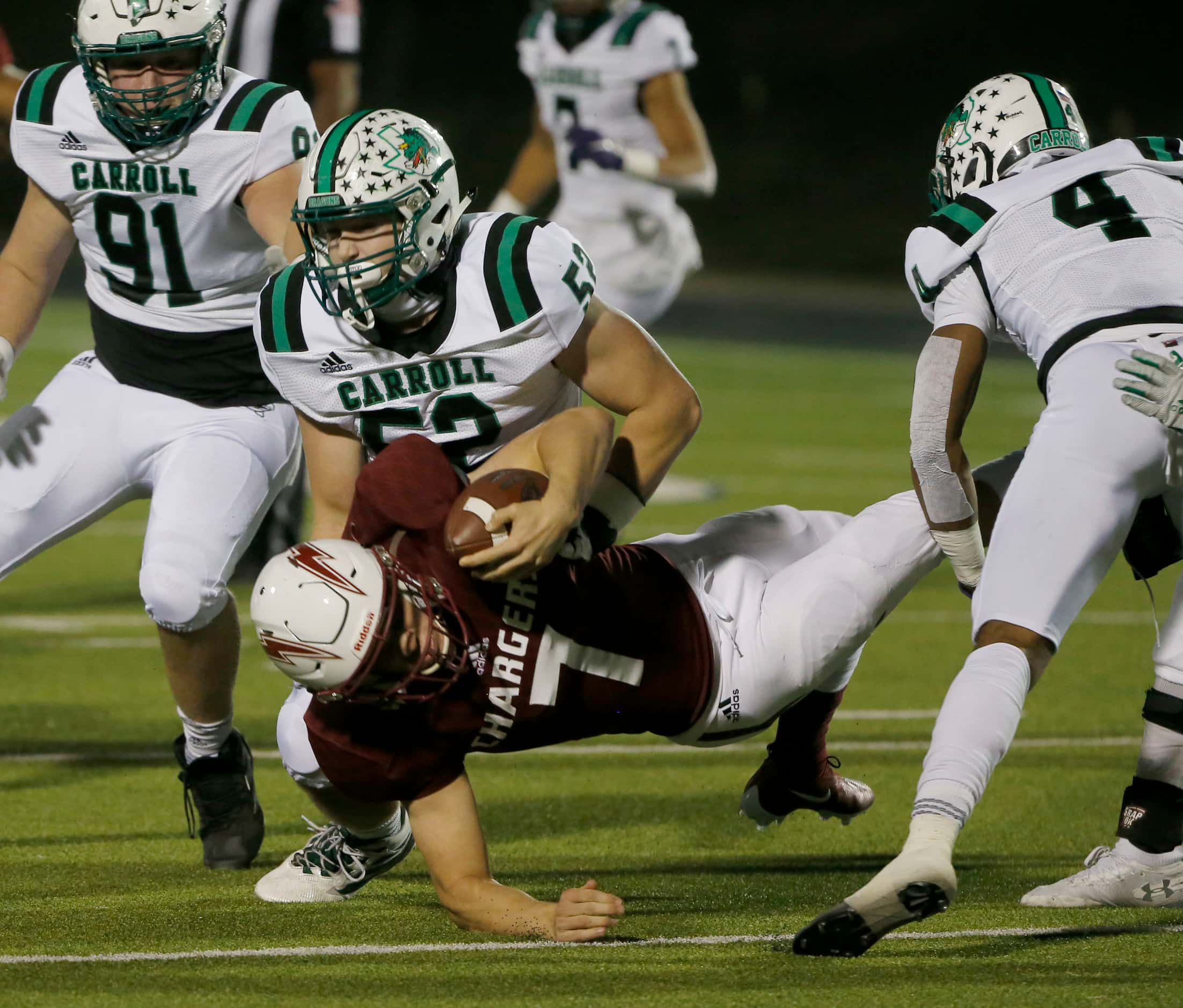 Southlake Carroll’s Cade Parks (52) and Cinque Williams (4) tackle Keller Central...