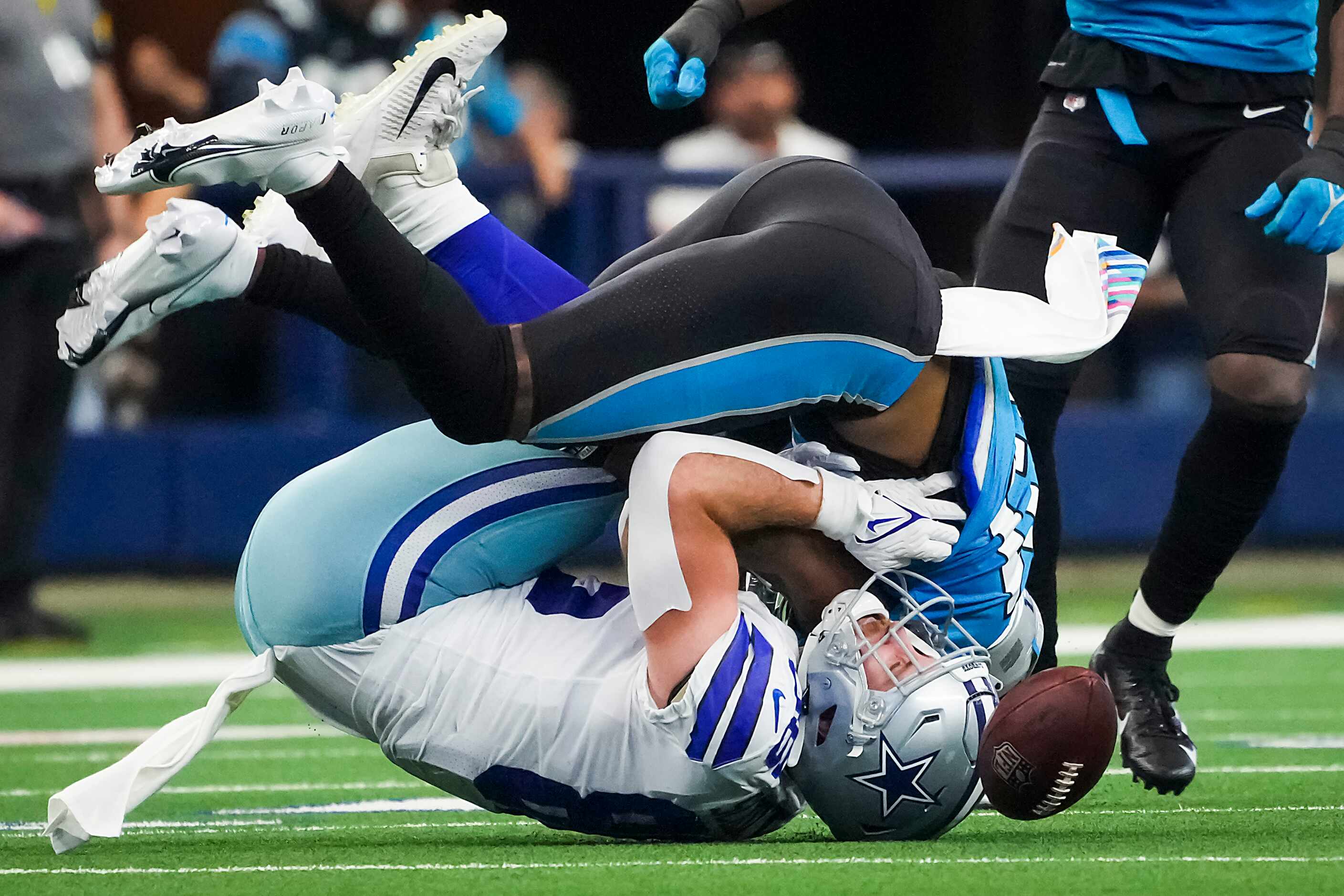 Dallas Cowboys tight end Dalton Schultz (86) is brought down by Carolina Panthers safety...