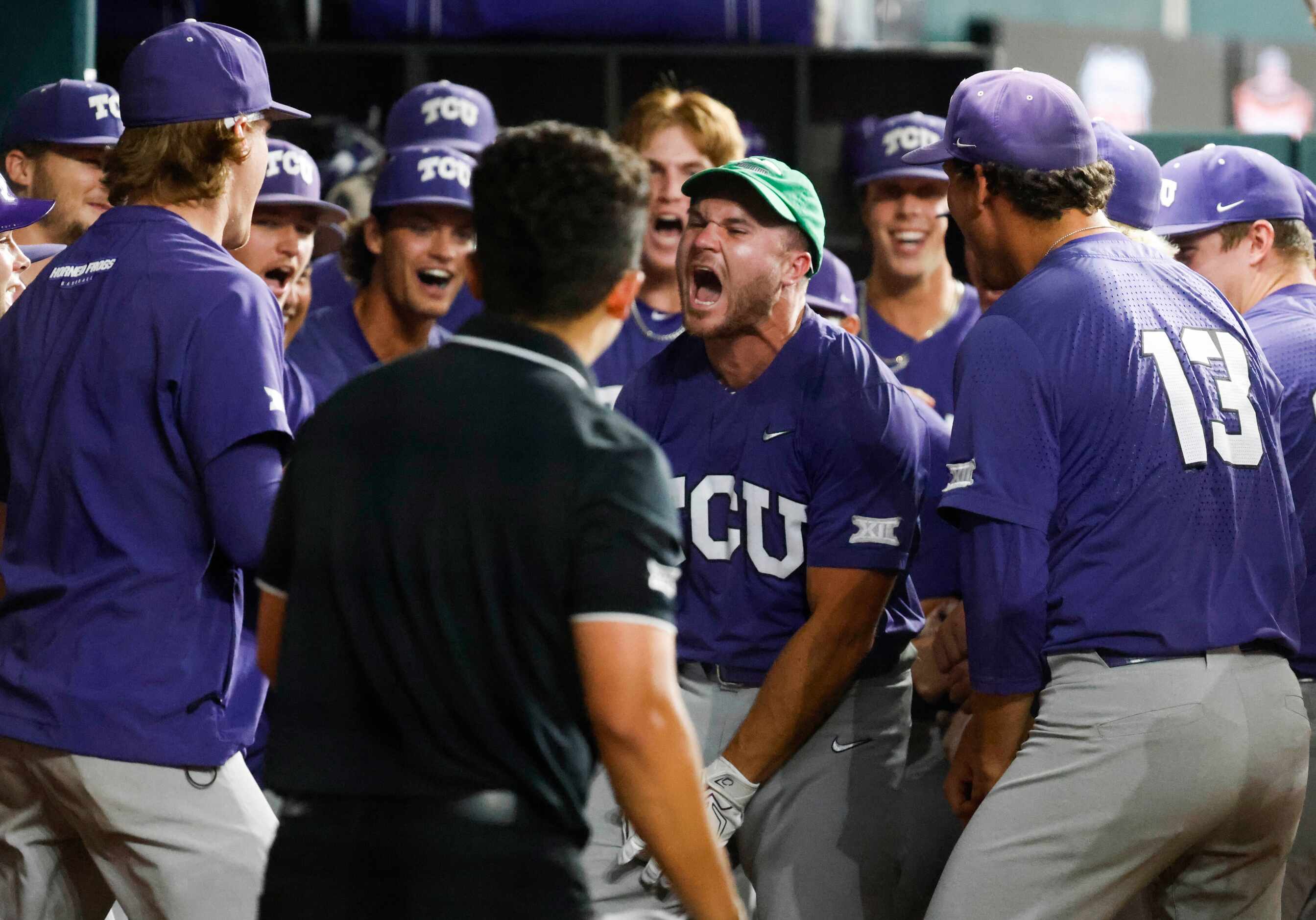TCU outfielder Luke Boyers (front) cheers in the dugout after a three run homer during the...