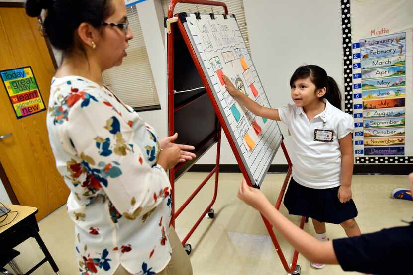 First-grade teacher Annette Hinojosa worked with student Zoe Avalos during a class activity...