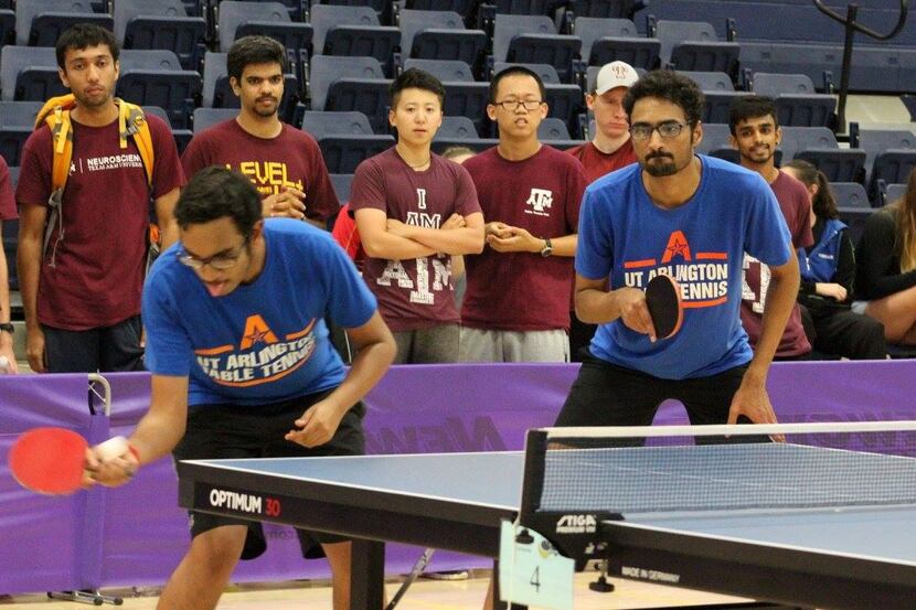 Members of the University of Texas at Arlington table tennis team compete in a tournament. 