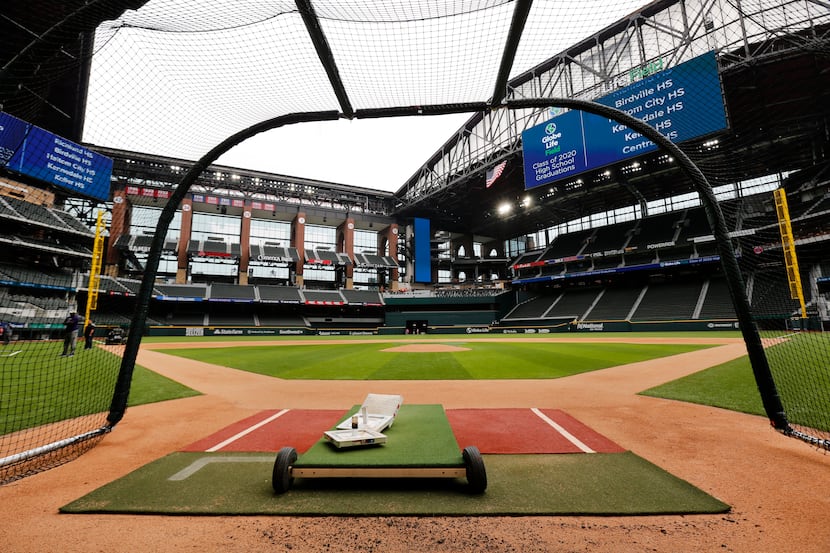 Texas Rangers players have been using a batting cage on the field of the newly completed...