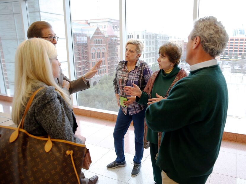 Attorneys Tom Whelan (second from left) and Jennifer Ryback  talk with Alicia Parrill,...