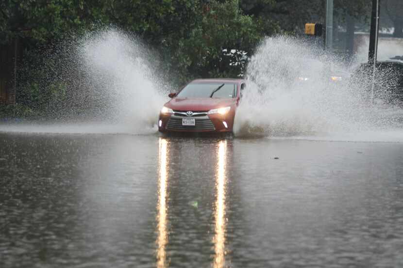 A driver drove around police cars and through flood waters on Hillcrest Road just south of...