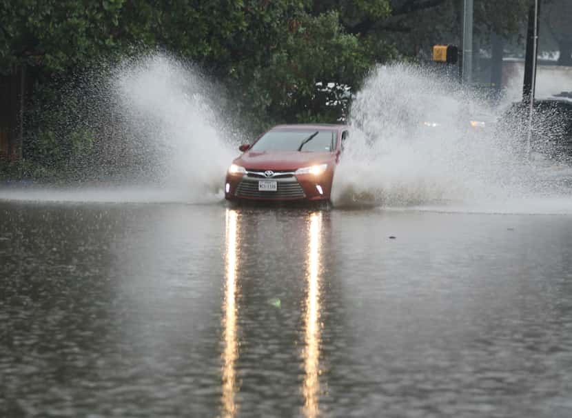 A driver drove around police cars and through floodwaters on Hillcrest Road just south of...