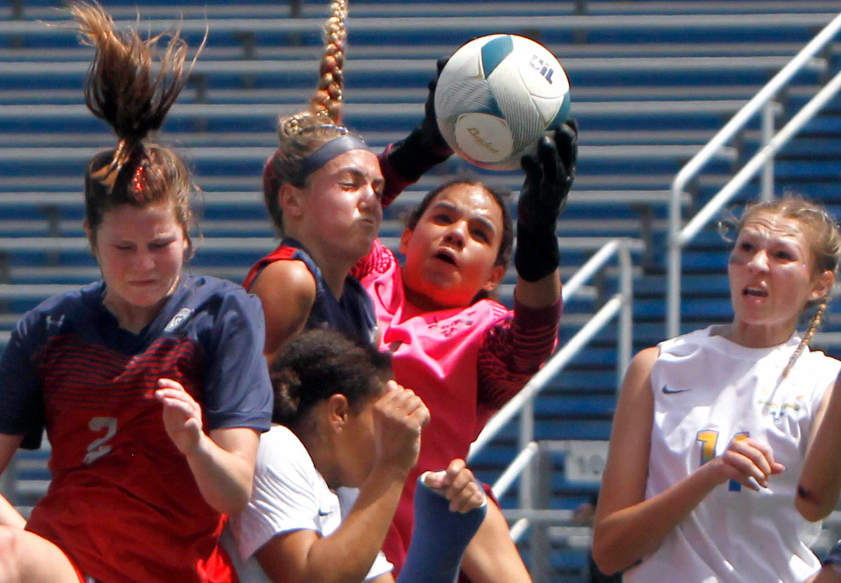 Frisco goalkeeper Ariana Anderson (1) leaps to make a save in a crowd during first half...