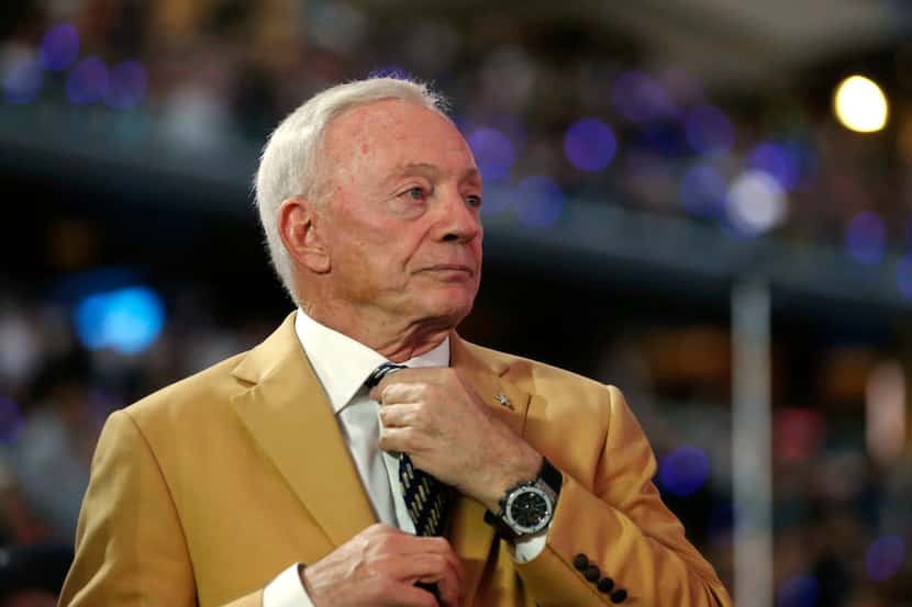 Dallas Cowboys owner and general manager Jerry Jones adjusts his tie before the halftime Pro...